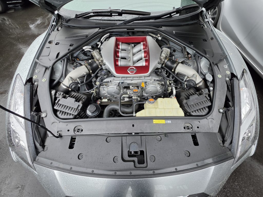 ボンネット内。赤いインテークマニホールドのVR38DETT